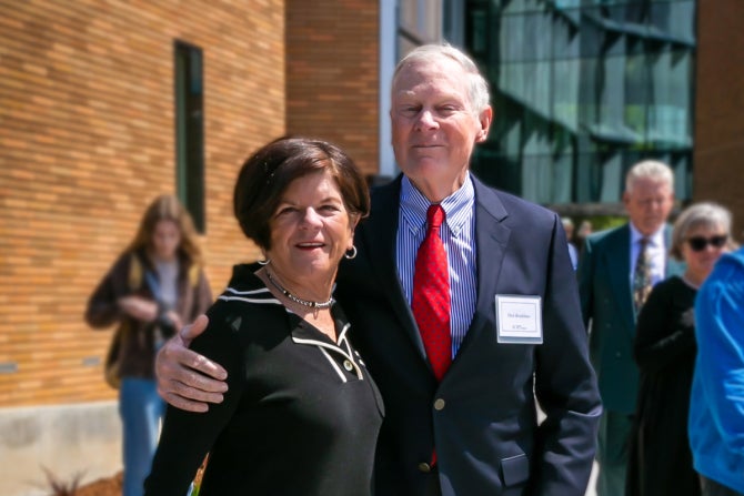 Richard and Peggy Bradshaw pose in front of the Frost Center